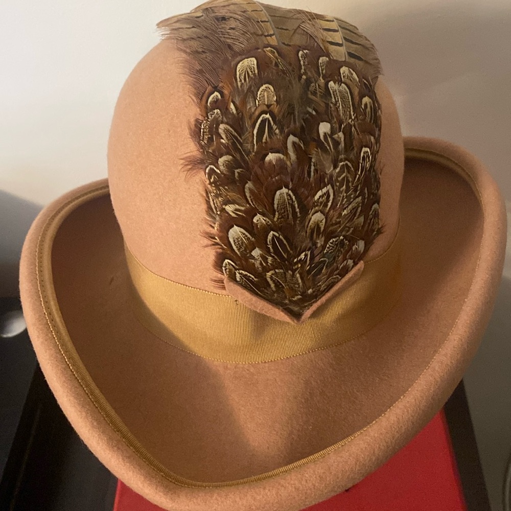 Light brown felt hat with multi brown feather detail.